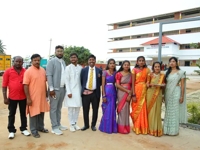 A line-up of teachers, guests and students on the forecourt with the school building rising behind