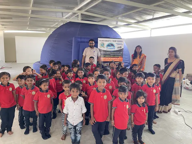 Children in red uniform queued outside a large inflatable planetarium dome in the school hall