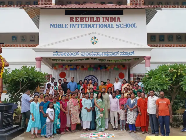 Wide school facade with the statue at left and a long line of adults and children in front