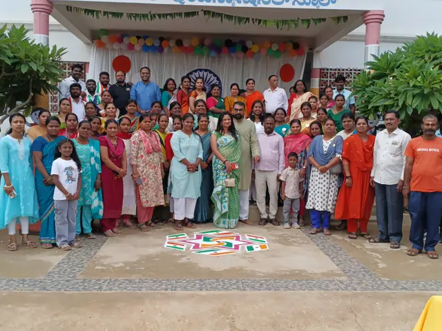 Women, men and children on the school forecourt with the decorated entrance behind