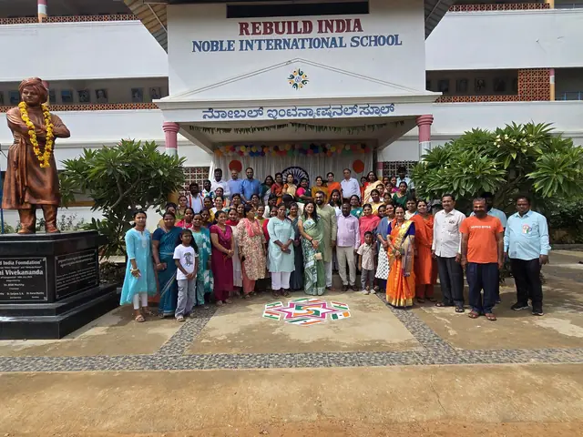 Wide establishing shot of the school building, statue on its plinth and the community lined up